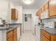 Efficient kitchen features granite countertops and all white appliances at 5550 E Michigan St # 2214, Orlando, FL 32822