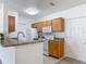 Bright kitchen with breakfast bar, modern appliances, and neutral color scheme at 5550 E Michigan St # 2214, Orlando, FL 32822