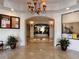 Inviting lobby featuring a decorative tiled floor, arched entryway, potted plants, and a bulletin board at 5550 E Michigan St # 2214, Orlando, FL 32822
