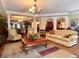 This is a spacious lounge area featuring hardwood floors and neutral-toned furniture at 5550 E Michigan St # 2214, Orlando, FL 32822