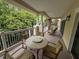 Spacious balcony is furnished with a table and chairs, great for enjoying the outdoors at 7658 Whisper Way # 203, Reunion, FL 34747