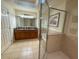 Bright bathroom featuring a double sink vanity, soaking tub and glass enclosed shower at 7658 Whisper Way # 203, Reunion, FL 34747