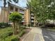 Inviting exterior view of the property showing the multiple balconies and landscaped walkway at 7658 Whisper Way # 203, Reunion, FL 34747