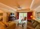 Comfortable living room features nice furniture, ceiling fan, and a sliding glass door to a balcony at 7658 Whisper Way # 203, Reunion, FL 34747