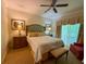 Serene main bedroom with a large bed, soft lighting, and access to an outdoor balcony at 7658 Whisper Way # 203, Reunion, FL 34747