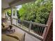 Covered patio with ample seating and beautiful views of mature trees at 7658 Whisper Way # 203, Reunion, FL 34747