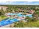 An aerial view showcasing a sprawling community pool and splash pad at 7719 Comrow St, Kissimmee, FL 34747
