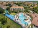 Aerial view of community featuring a resort-style pool and water slides and landscaped grounds at 7719 Comrow St, Kissimmee, FL 34747