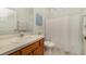 Bright bathroom with a vanity, sink, toilet, and a shower with a white curtain at 7719 Comrow St, Kissimmee, FL 34747