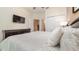 Bright bedroom with neutral tones, featuring a TV, closet space, and access to other rooms at 7719 Comrow St, Kissimmee, FL 34747