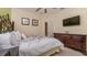 Well-lit bedroom showcasing a bed, dresser, mounted television, and tasteful decorations at 7719 Comrow St, Kissimmee, FL 34747