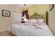Cozy bedroom featuring a wrought iron bed frame, floral bedding, and a closet at 7719 Comrow St, Kissimmee, FL 34747