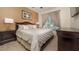 Comfortable bedroom featuring a large bed, elegant furnishings, and plenty of natural light from the window at 7719 Comrow St, Kissimmee, FL 34747