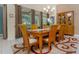 Bright dining area featuring a wooden table, chairs, and view of the outdoor living space at 7719 Comrow St, Kissimmee, FL 34747