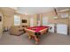 Spacious game room featuring a pool table, comfortable seating, and laundry appliances at 7719 Comrow St, Kissimmee, FL 34747