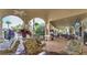 Covered lounge area with comfortable seating and multiple televisions for relaxation at 7719 Comrow St, Kissimmee, FL 34747