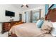 Relaxing main bedroom with a large bed, dresser, and natural light coming in from backyard at 7719 Comrow St, Kissimmee, FL 34747