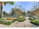 A view of a landscaped community park featuring walking paths and a merry-go-round at 7719 Comrow St, Kissimmee, FL 34747