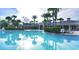 A beautiful community pool with clear blue water and palm tree landscaping at 7719 Comrow St, Kissimmee, FL 34747