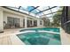 Screened-in pool with a spa and outdoor seating area accessible from the home's interior at 7719 Comrow St, Kissimmee, FL 34747