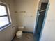 Bathroom featuring a toilet, shower, window, and a towel rack at 8 Emerald Way, Ocala, FL 34472