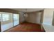 Dining room with chandelier, sliding doors to Florida room, and outdated orange carpet at 8 Emerald Way, Ocala, FL 34472