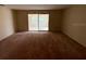 Empty living room featuring orange carpet and sliding glass doors at 8 Emerald Way, Ocala, FL 34472