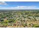 An expansive aerial view of a neighborhood with mature trees in a sunny day at 832 Whalebone Bay Dr, Kissimmee, FL 34741