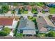 Aerial view showcasing the home, its manicured lawn, and the serene neighborhood pond at 832 Whalebone Bay Dr, Kissimmee, FL 34741