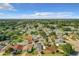 Aerial view of a neighborhood showcasing homes with pools and mature landscaping in a sunny setting at 832 Whalebone Bay Dr, Kissimmee, FL 34741