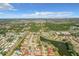 An aerial view of a peaceful neighborhood with homes surrounded by lakes and mature trees at 832 Whalebone Bay Dr, Kissimmee, FL 34741