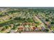 An aerial view of homes near a pond with a fountain surrounded by verdant landscaping at 832 Whalebone Bay Dr, Kissimmee, FL 34741