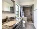 Updated bathroom features a sink with a marble countertop, framed mirror, and decorative tiled shower at 832 Whalebone Bay Dr, Kissimmee, FL 34741