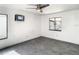 Spacious bedroom with gray tile floors, ceiling fan, and a window for natural light at 832 Whalebone Bay Dr, Kissimmee, FL 34741