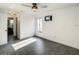 Spacious bedroom with gray tile floors, ceiling fan, and a window for natural light at 832 Whalebone Bay Dr, Kissimmee, FL 34741