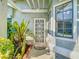 Front door entryway with decorative glass, plants, and natural light at 832 Whalebone Bay Dr, Kissimmee, FL 34741