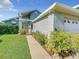 Home exterior showing walkway with beautiful shrubbery and manicured lawn at 832 Whalebone Bay Dr, Kissimmee, FL 34741