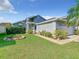 Well-maintained single Gathering home with lush green grass and walkway to the front door at 832 Whalebone Bay Dr, Kissimmee, FL 34741