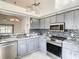 Well-lit kitchen with stainless steel appliances, stylish backsplash, and ample counter space at 832 Whalebone Bay Dr, Kissimmee, FL 34741