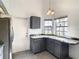 Bright kitchen area with breakfast bar, gray cabinetry, and natural light at 832 Whalebone Bay Dr, Kissimmee, FL 34741