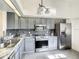 Clean and updated kitchen with stainless steel appliances, gray cabinetry, and tile flooring at 832 Whalebone Bay Dr, Kissimmee, FL 34741