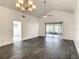 Bright living room features vaulted ceiling, stylish floors, and sliding glass doors to the lanai at 832 Whalebone Bay Dr, Kissimmee, FL 34741