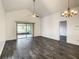 Bright living room with vaulted ceiling, stylish flooring, and access to a screened-in lanai at 832 Whalebone Bay Dr, Kissimmee, FL 34741