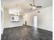 Spacious living room with modern flooring, vaulted ceilings, and access to other areas of the home at 832 Whalebone Bay Dr, Kissimmee, FL 34741
