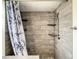Tiled shower with leaf shower curtain, built-in shelving and rainfall shower head at 832 Whalebone Bay Dr, Kissimmee, FL 34741