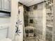 Updated bathroom shower with decorative tile and a built-in corner seat at 832 Whalebone Bay Dr, Kissimmee, FL 34741