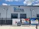 Front view of the Adventure Park building with signage and promotional posters at 8338 Modiano St, Orlando, FL 32827