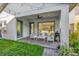 Inviting covered patio with stylish outdoor seating, string lights, and convenient access to the home's interior at 8338 Modiano St, Orlando, FL 32827