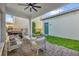 Cozy covered patio featuring brick pavers, comfortable seating, and a ceiling fan for outdoor relaxation at 8338 Modiano St, Orlando, FL 32827
