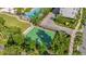 Aerial shot of the community basketball court with lush surrounding trees and a nearby pool for active living at 8338 Modiano St, Orlando, FL 32827